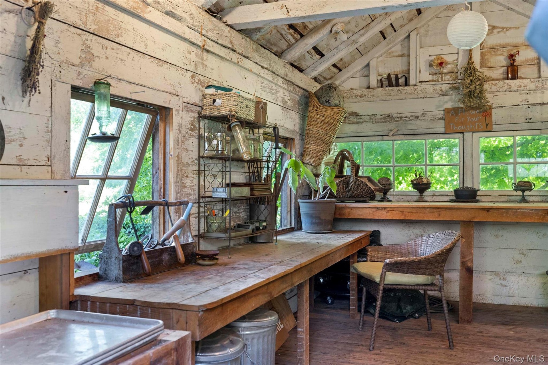 Charming potting shed with generous potting benches, abundant workspace, and period character