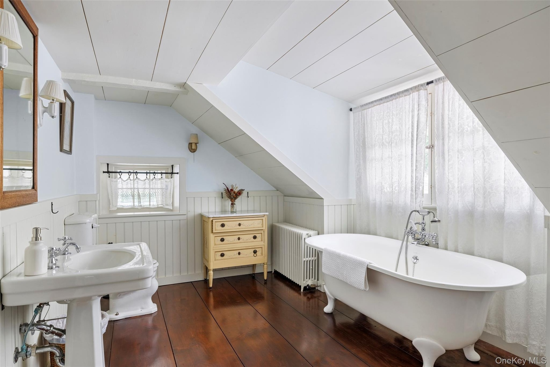 Charming upstairs bathroom with classic clawfoot soaking tub