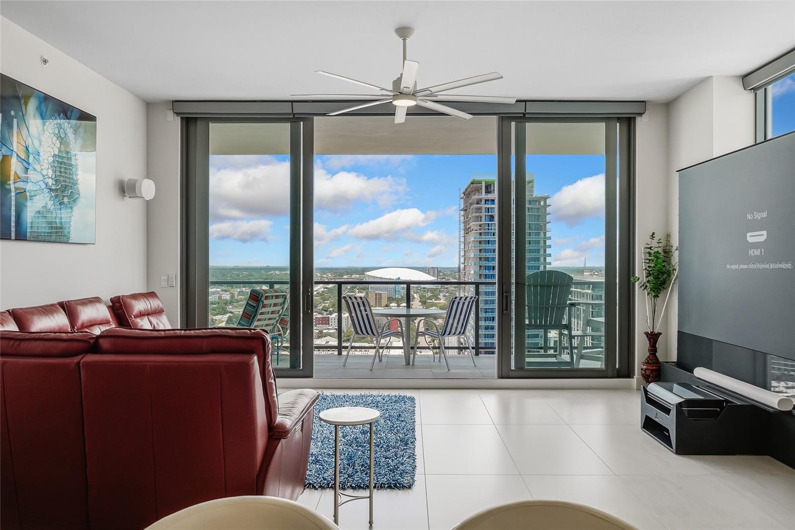 “smart” family room features a comfortable leather sofa with three motorized loungers, a 120” state-of-the-art projection TV that rises from the floor