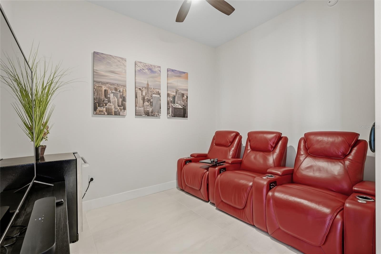Den with motorized leather couch seating