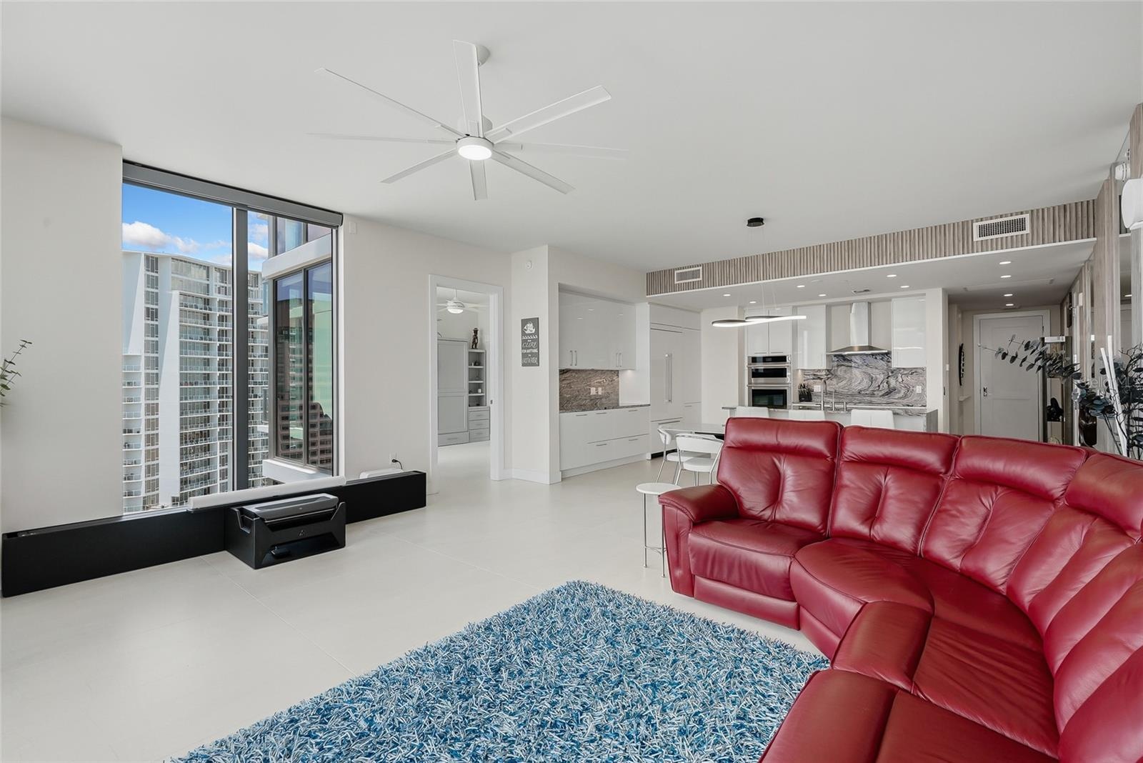 “smart” family room features a comfortable leather sofa with three motorized loungers, a 120” state-of-the-art projection TV that rises from the floor