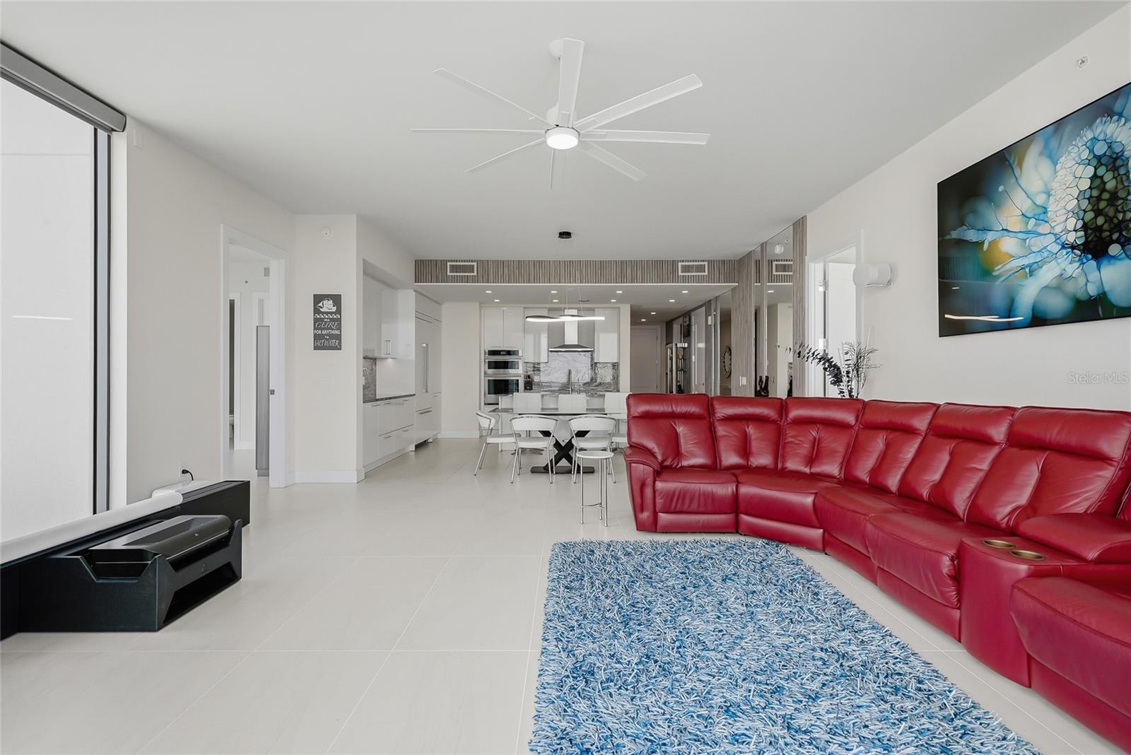 “smart” family room features a comfortable leather sofa with three motorized loungers, a 120” state-of-the-art projection TV that rises from the floor