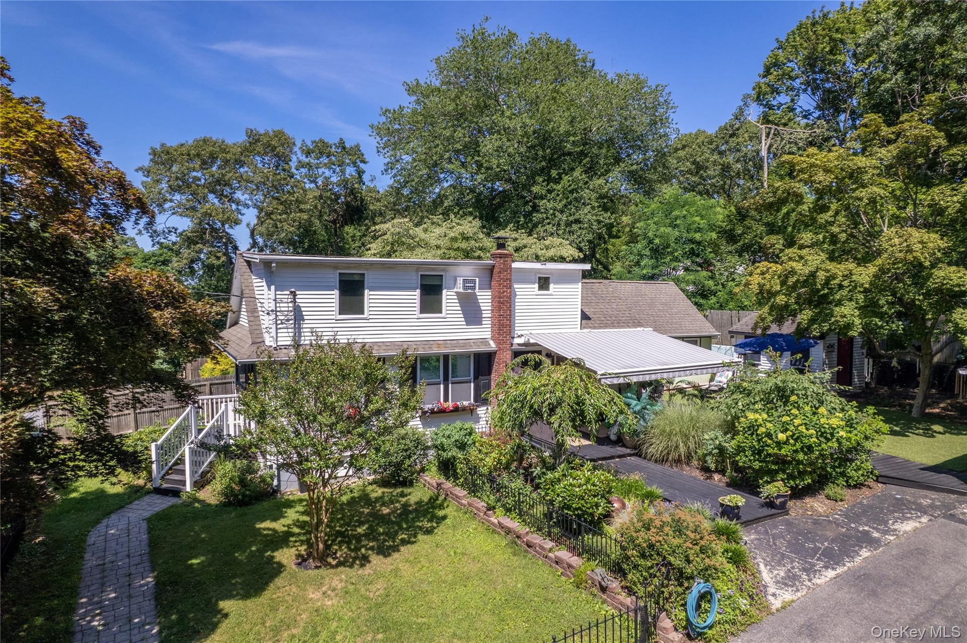 Extensive flowering gardens surround this unique property