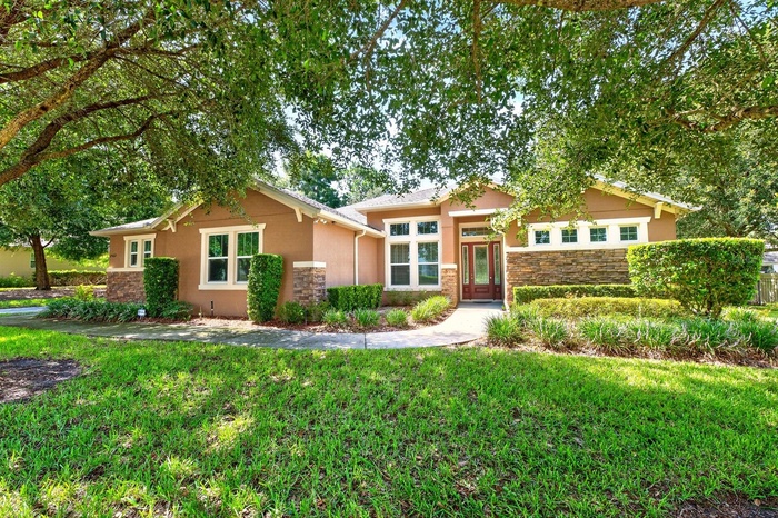 Set on a beautifully landscaped 1/3 ACRE LOT (.37) in the GATED Oak Ridge community of Apopka, this spacious 4-bedroom + office, 3-bath home offers th