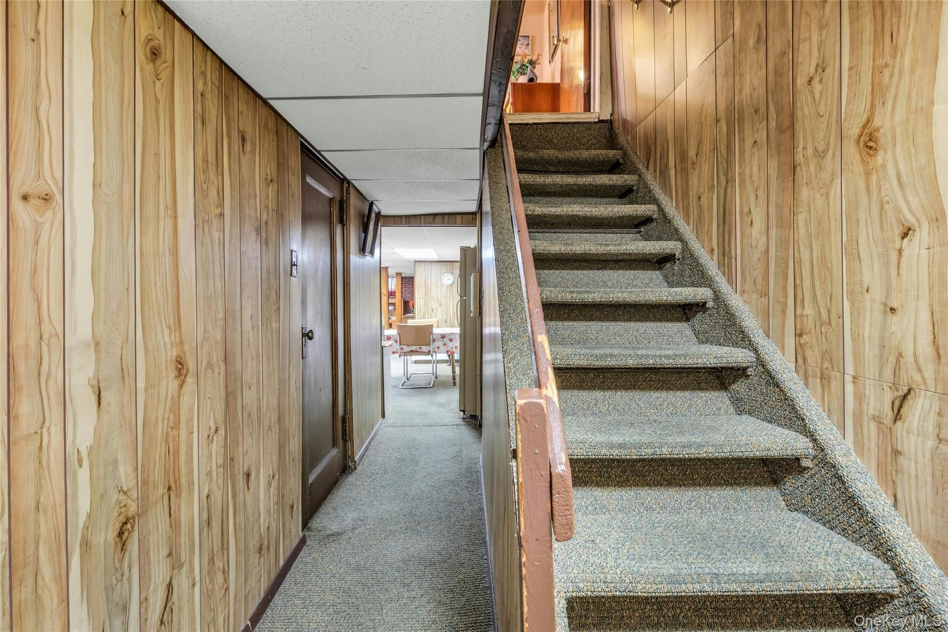 Garage door to the left. Basement steps lead into first floor unit.