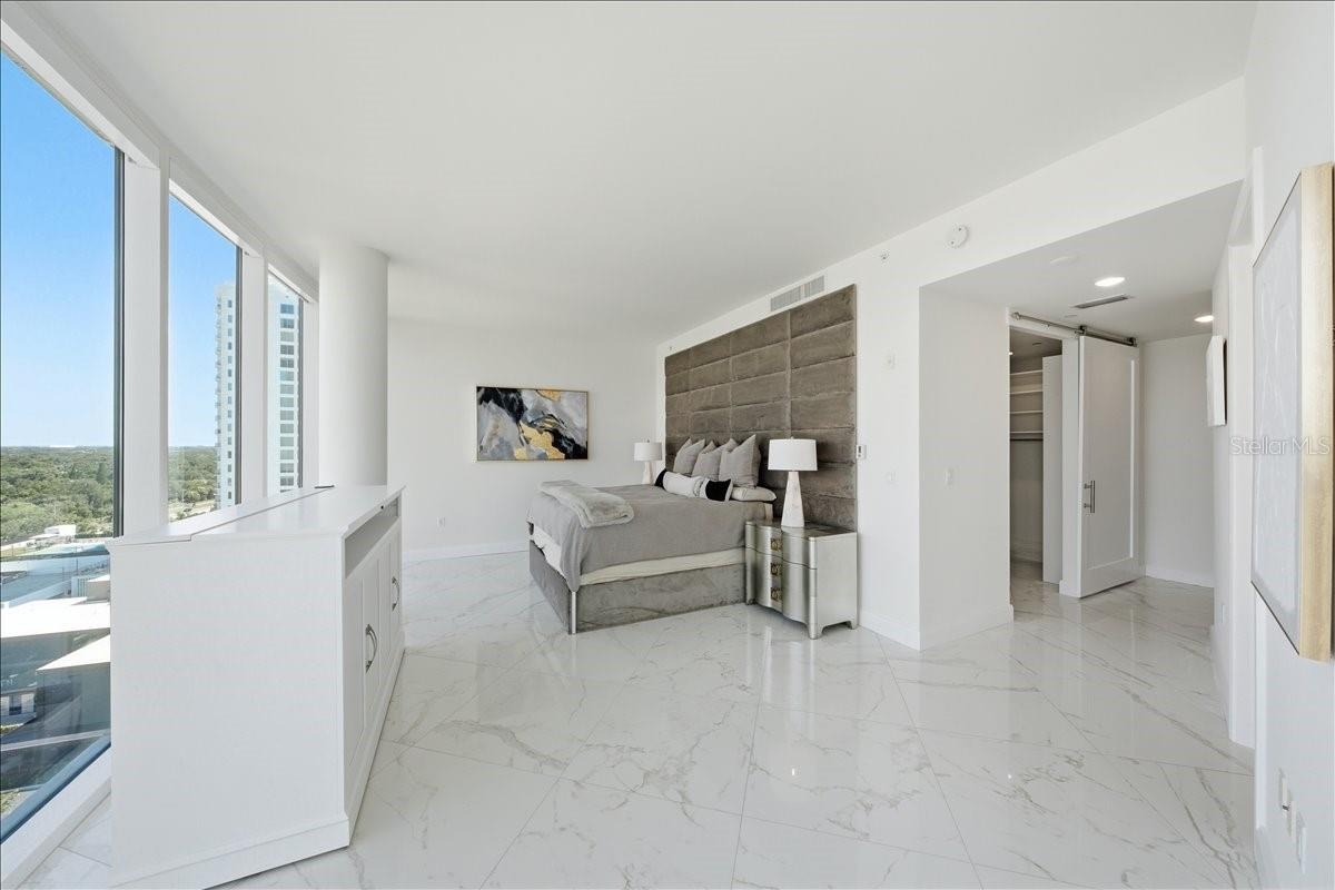Floor-to-ceiling glass and balcony access.