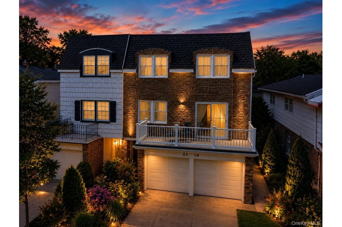 Stone and shingle-sided exterior with integrated two-car garage