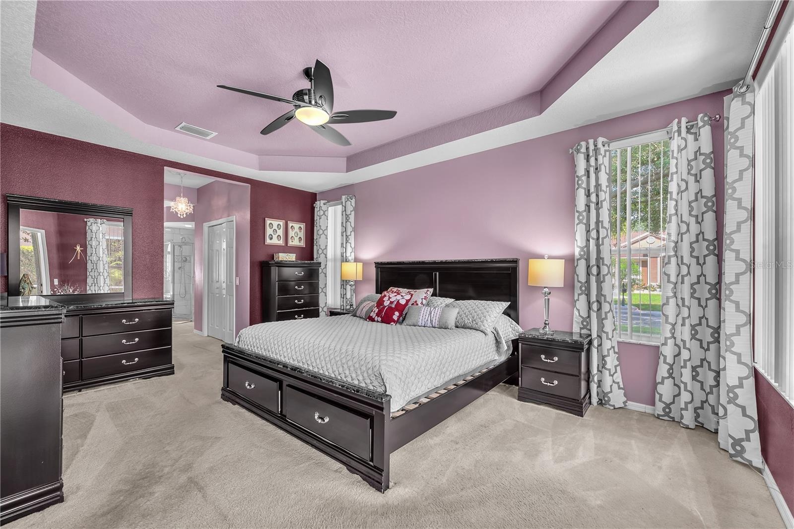 The owner's suite offers a peaceful escape with tray ceilings, multiple windows, dual walk-in closets, and a spacious en-suite bathroom.