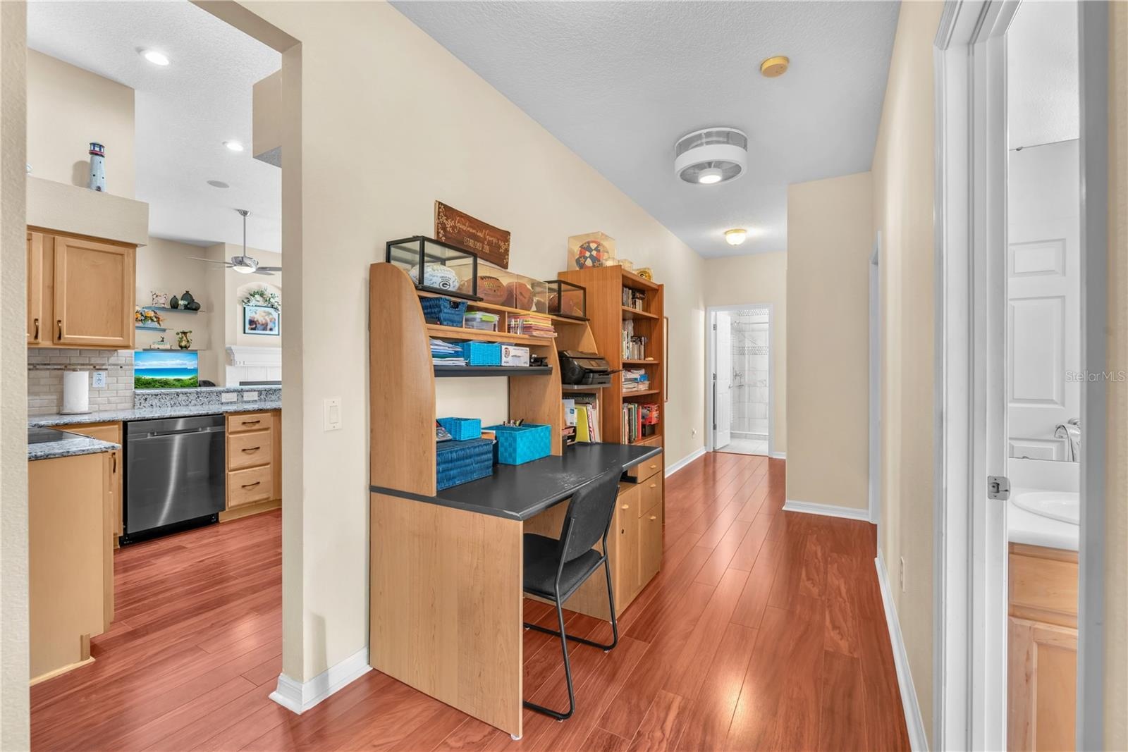 Three additional bedrooms are thoughtfully situated on the opposite side of the home, creating a private wing ideal for family and guests including a 