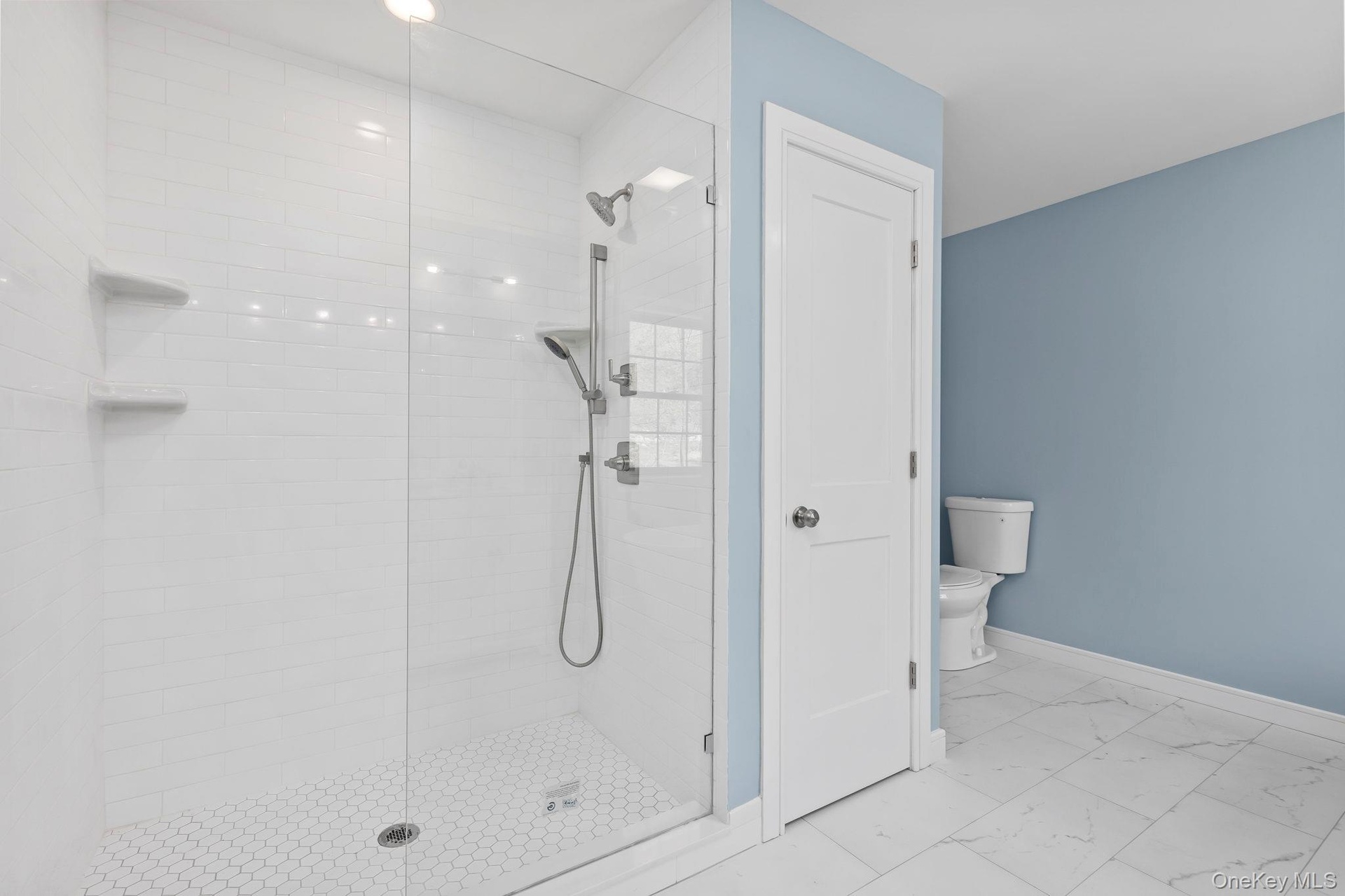 Previously built depicts linen closet, tiled floors and large walk in shower with glass enclosure. All subject to change
