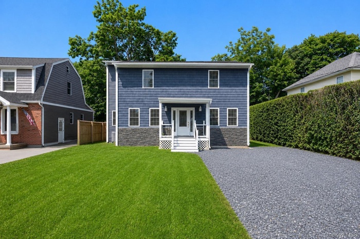 Two-story Colonial home with blue siding
