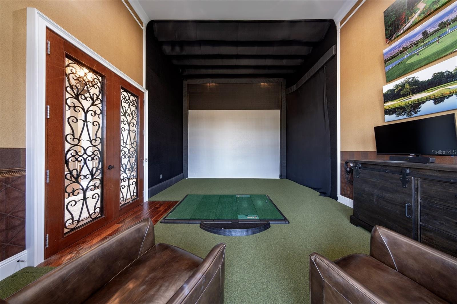 Office den space fitted for a golf simulator