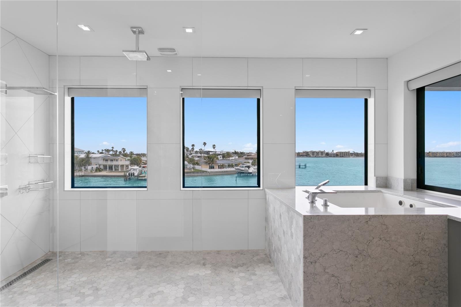 Open water view from the primary bathroom, oversized shower and tub