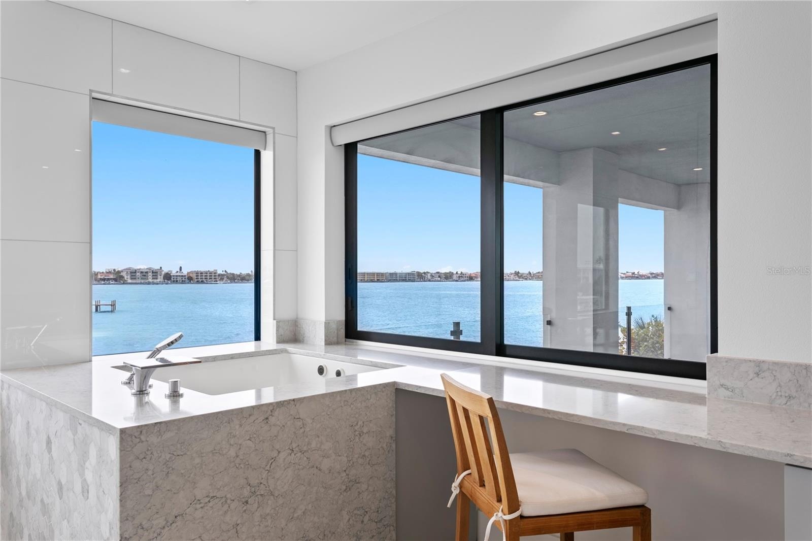 Open water view from the primary bathroom and soaking tub with jets
