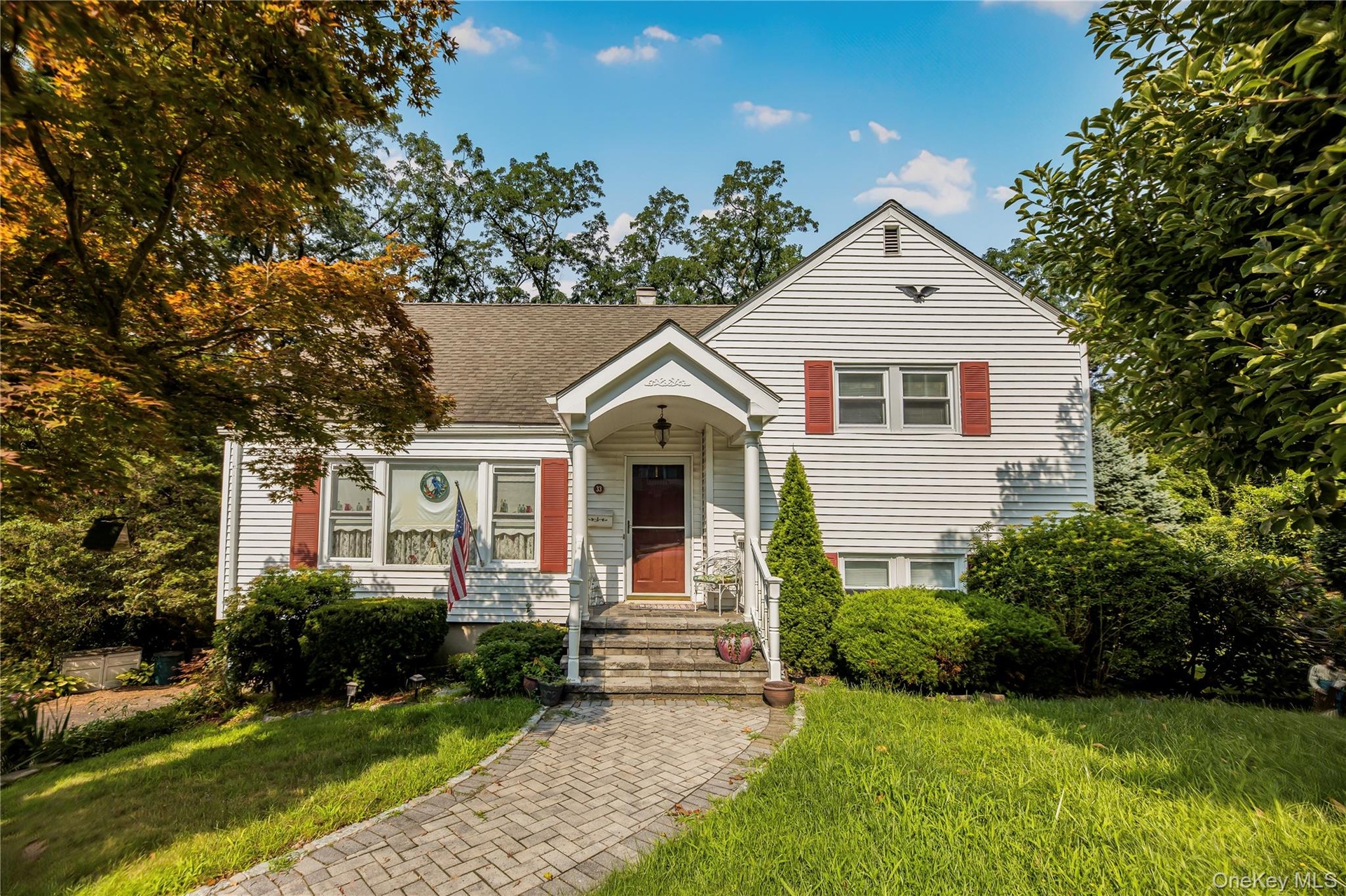 White siding exterior with red window shutters