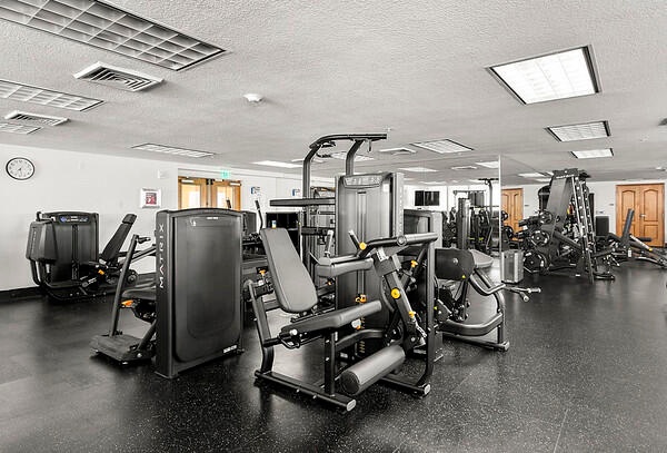 Gym adjacent to pool deck, sauna, steamroom & cabana baths