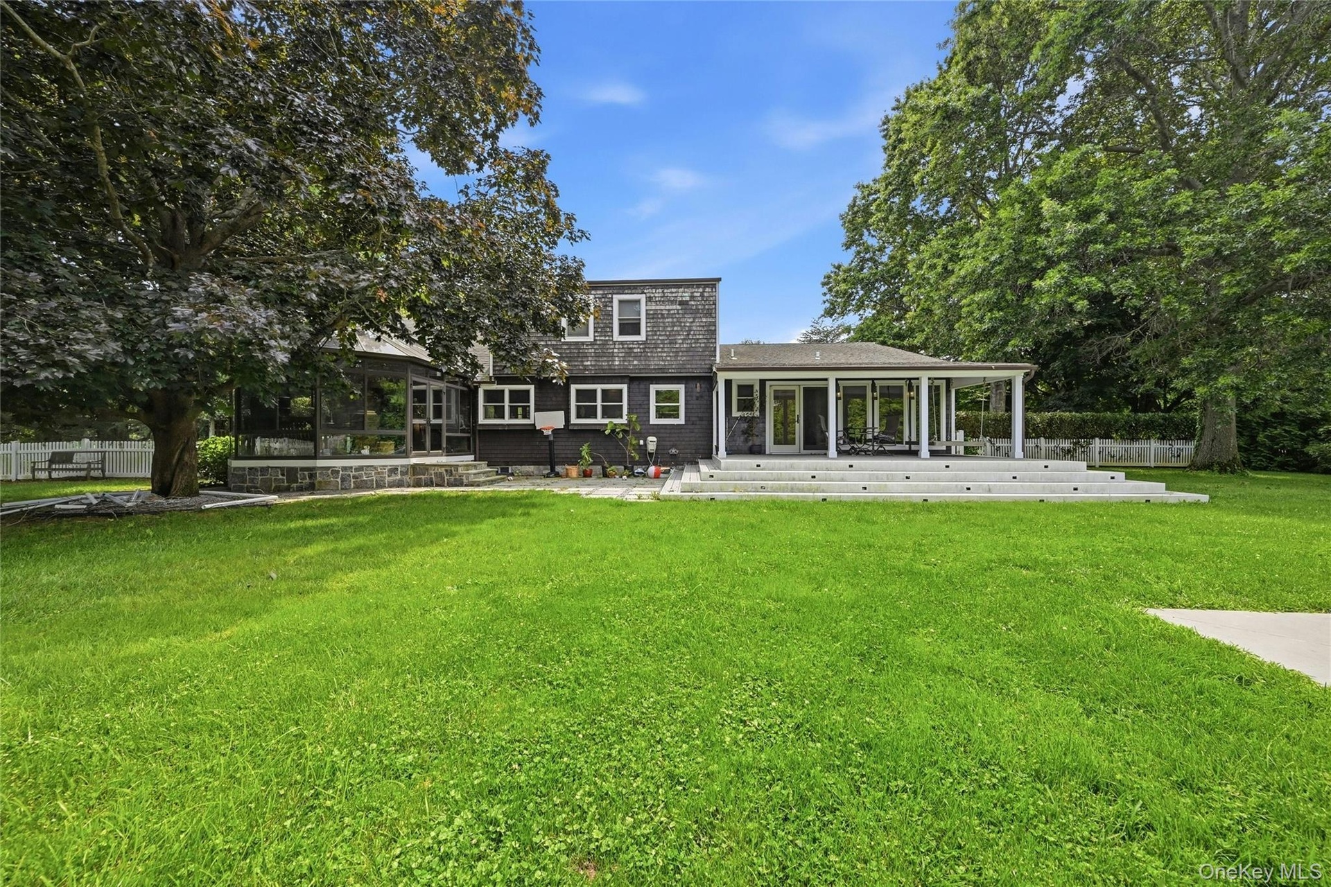Spacious backyard featuring a substantial lawn and mature trees