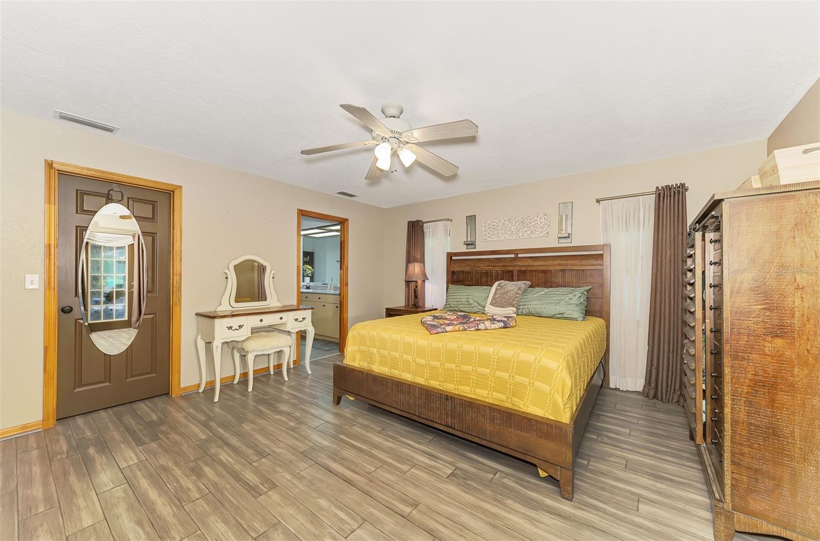 Primary bedroom with a huge walk in closet and private spa like bathroom