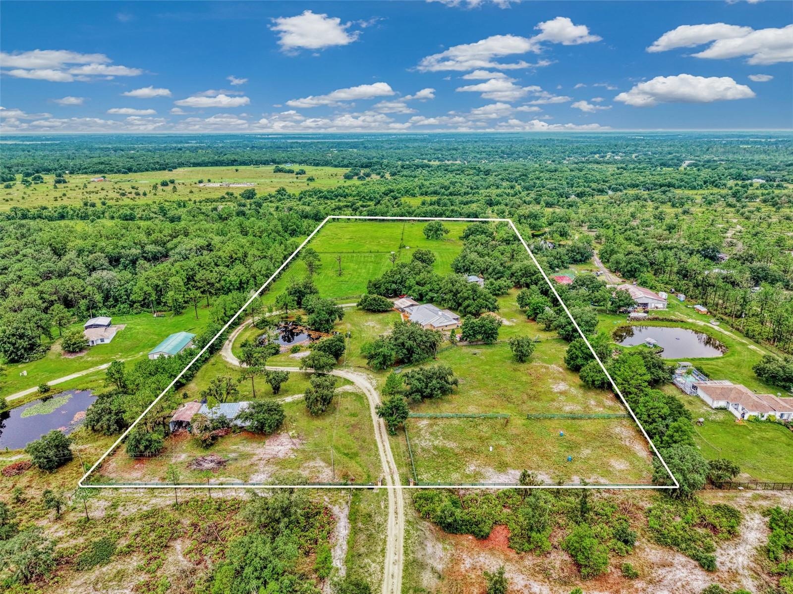 Turn onto 403rd st E and follow the long gravel driveway to the front gate