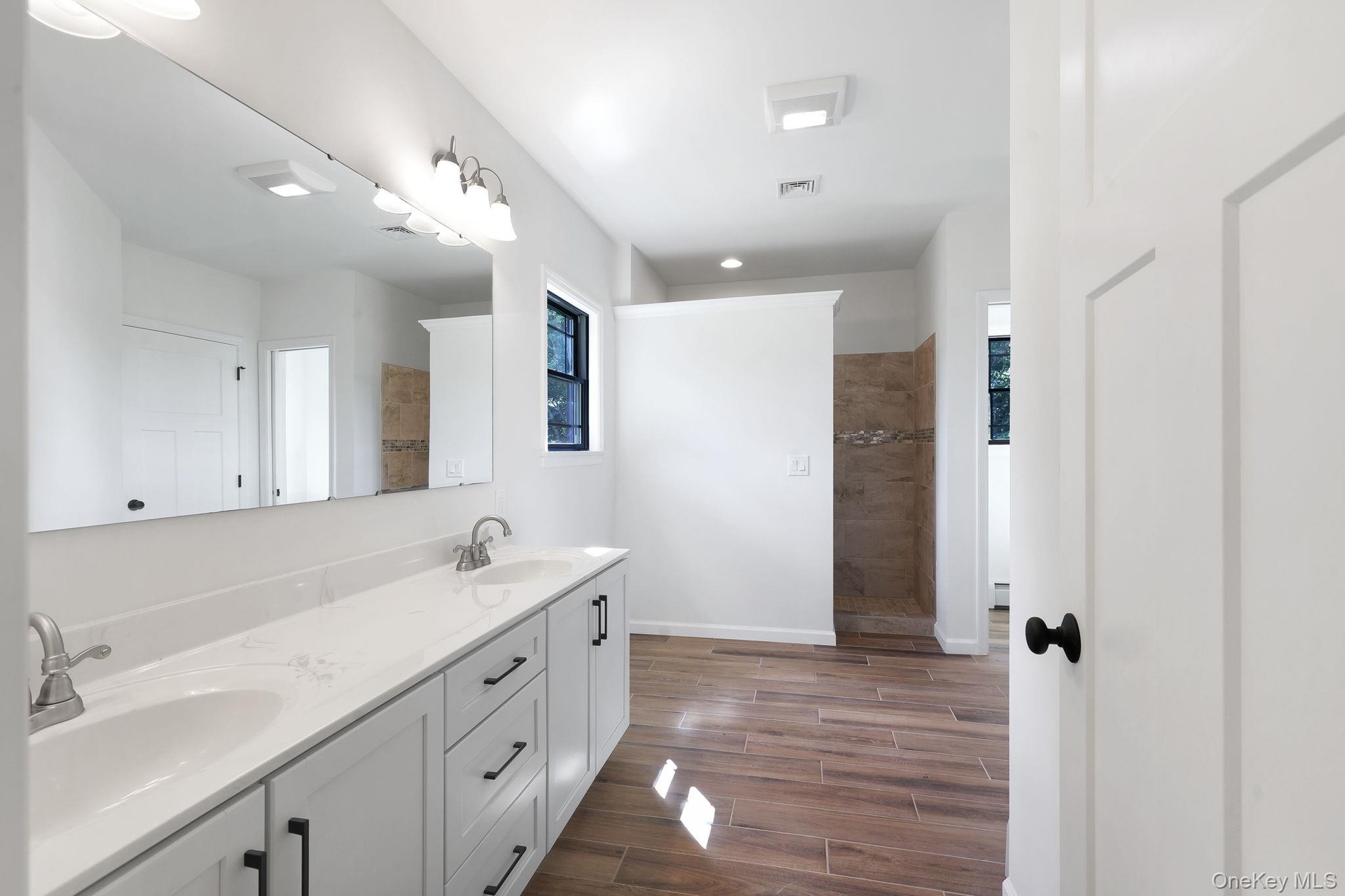 Walk-in shower and dual vanity in primary