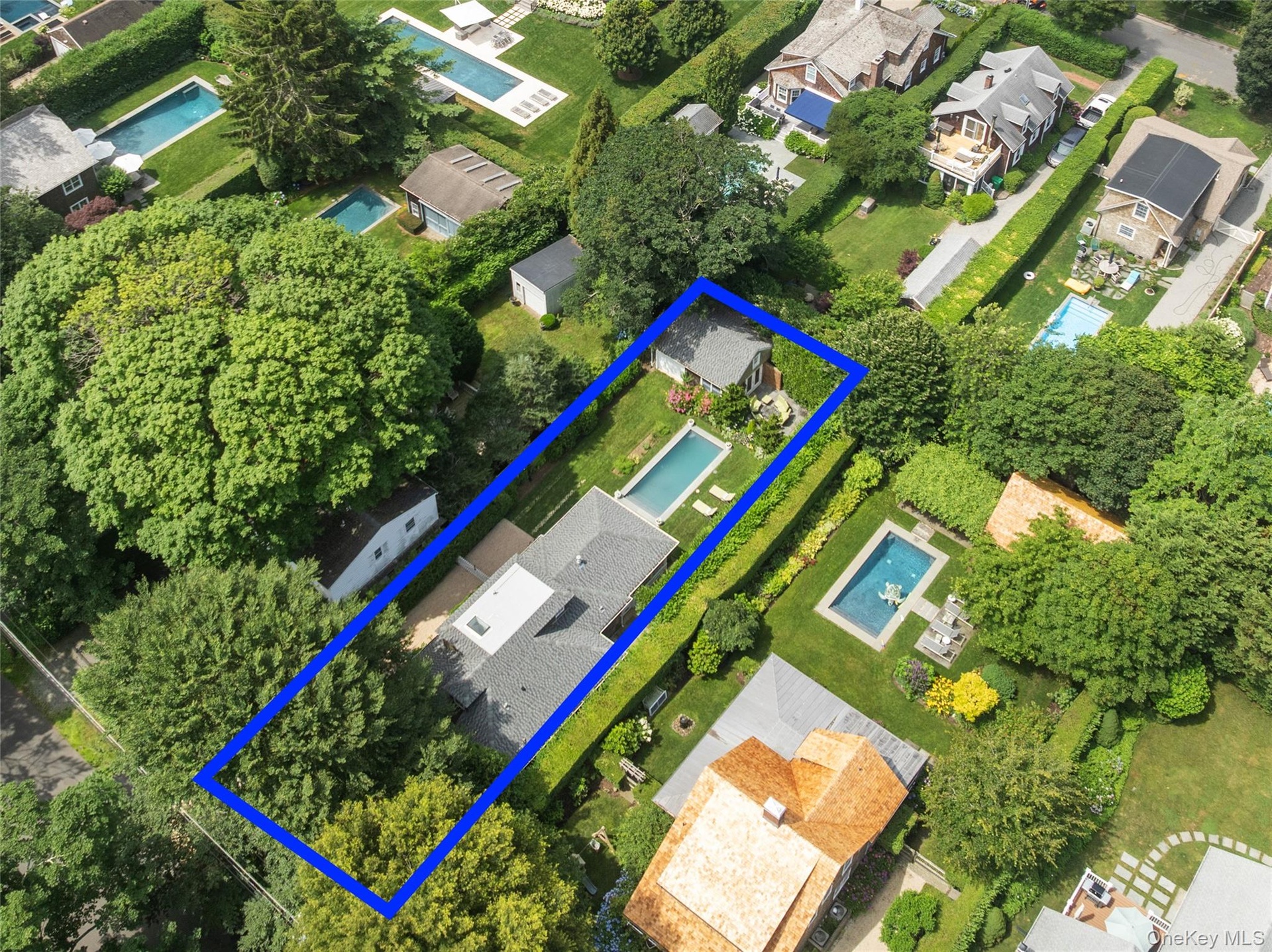 Aerial overview of property's location with nearby suburban area and property parcel outlined