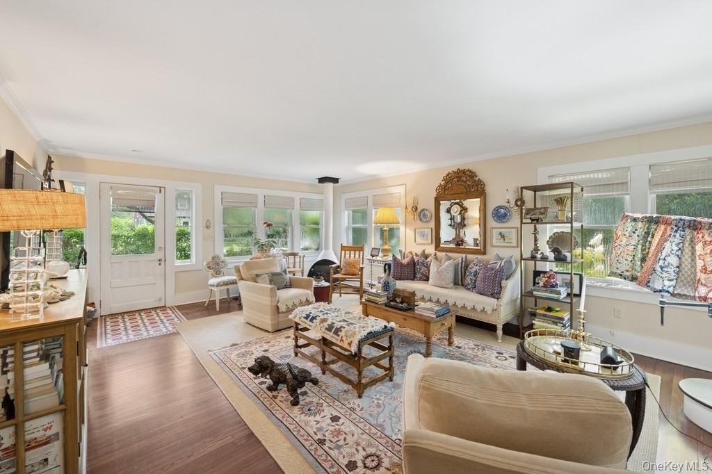Living room featuring wood finished floors and crown molding