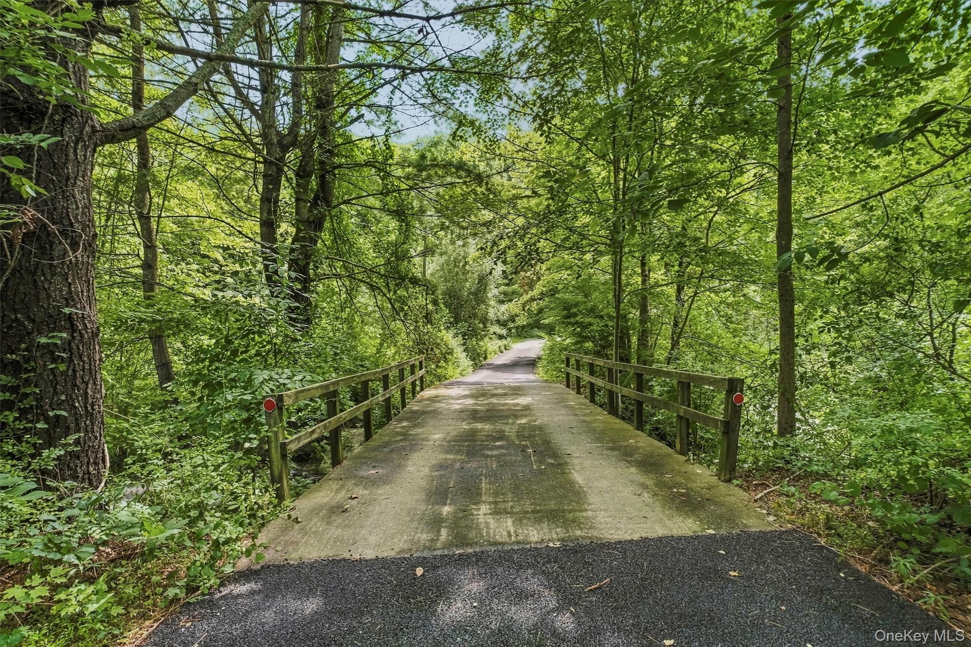 Privacy abounds as you travel over your own bridge into a natural sanctuary