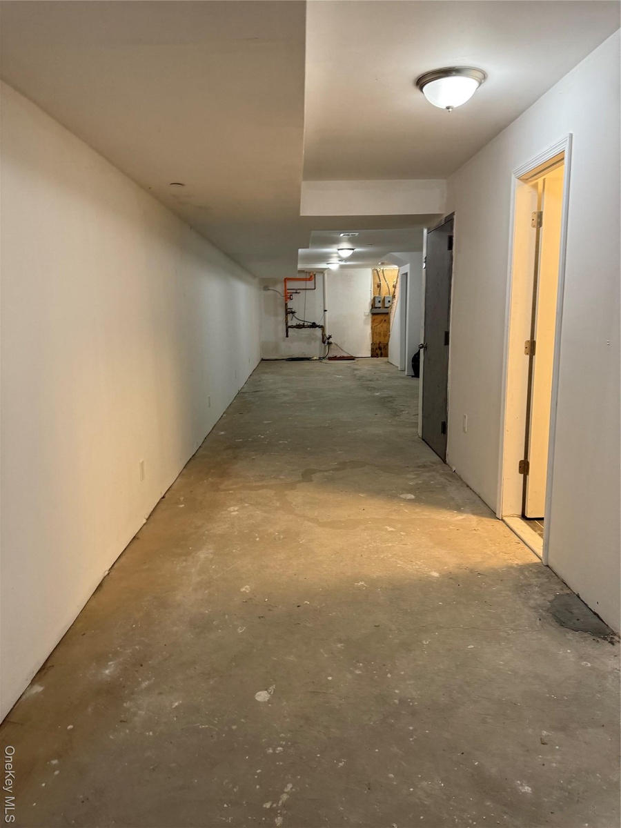 Hall featuring unfinished concrete floors