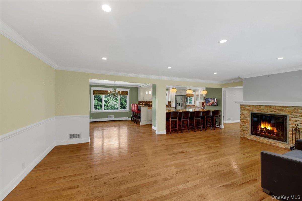 Living room with wainscoting, fire-place & hardwood floors