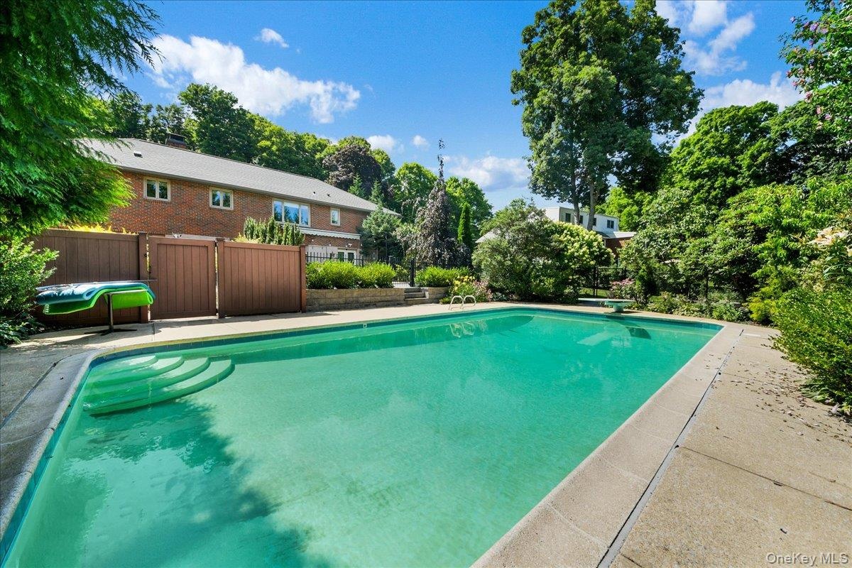 In ground pool with diving board and walk-in steps ... 38 ft wide ... 3FT low end up to 9FT deep end