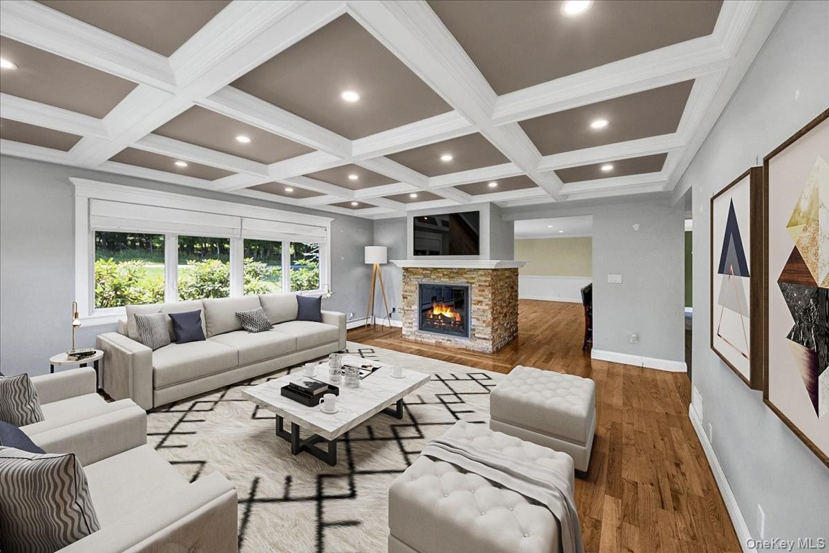 Second Living Room with beautifully decorated ceilings featuring recessed lighting, second fire-place and large windows throughout. Furniture has been