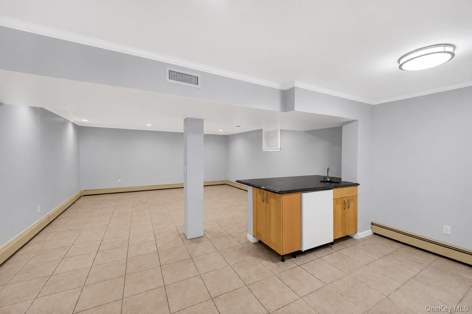 Finished lower level equipped with summer kitchen, bonus room & updated full bathroom