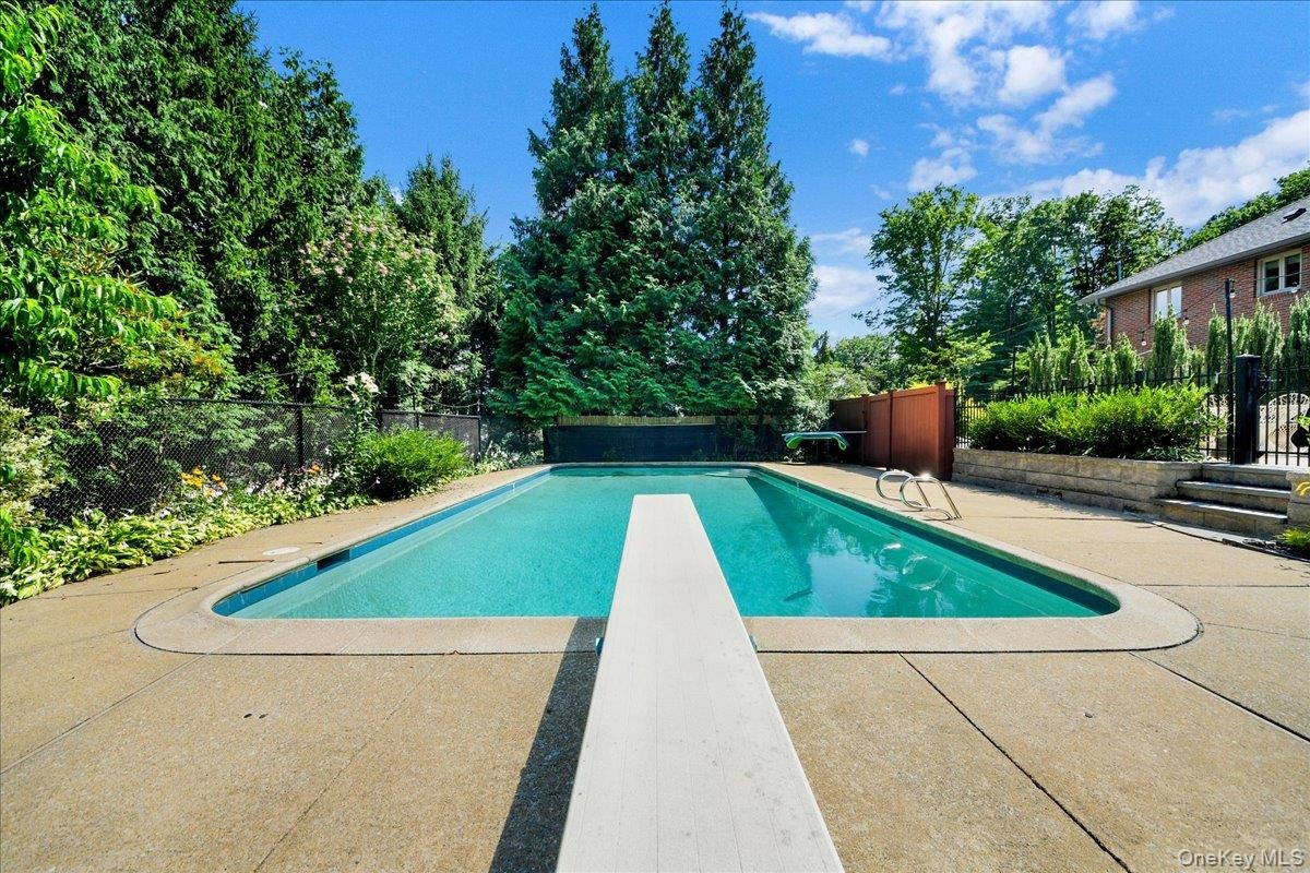 In ground pool with diving board and walk-in steps... 38 ft wide ... 3FT low end up to 9FT deep end