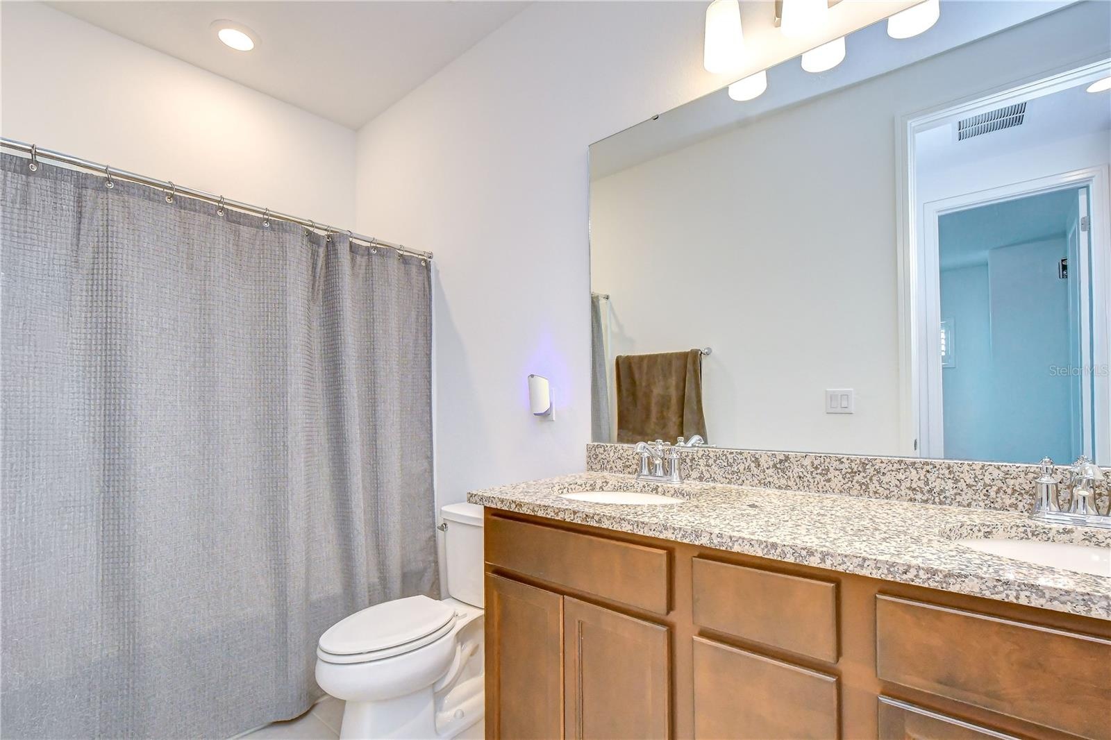 Additional full bath providing flexibility for family and visitors.