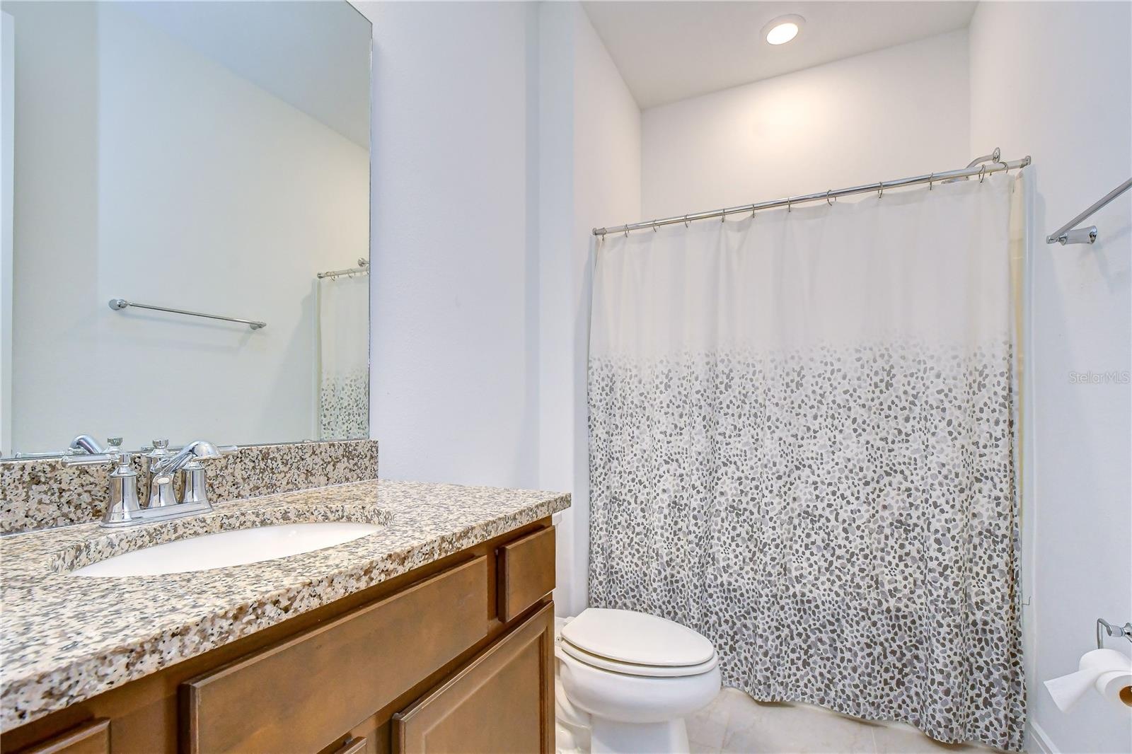Additional full bath providing flexibility for family and visitors.