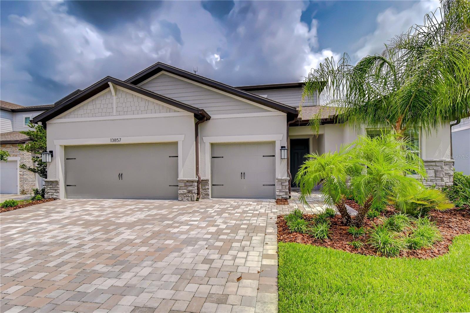 Oversized garage with carpeted flooring and exceptional versatility.