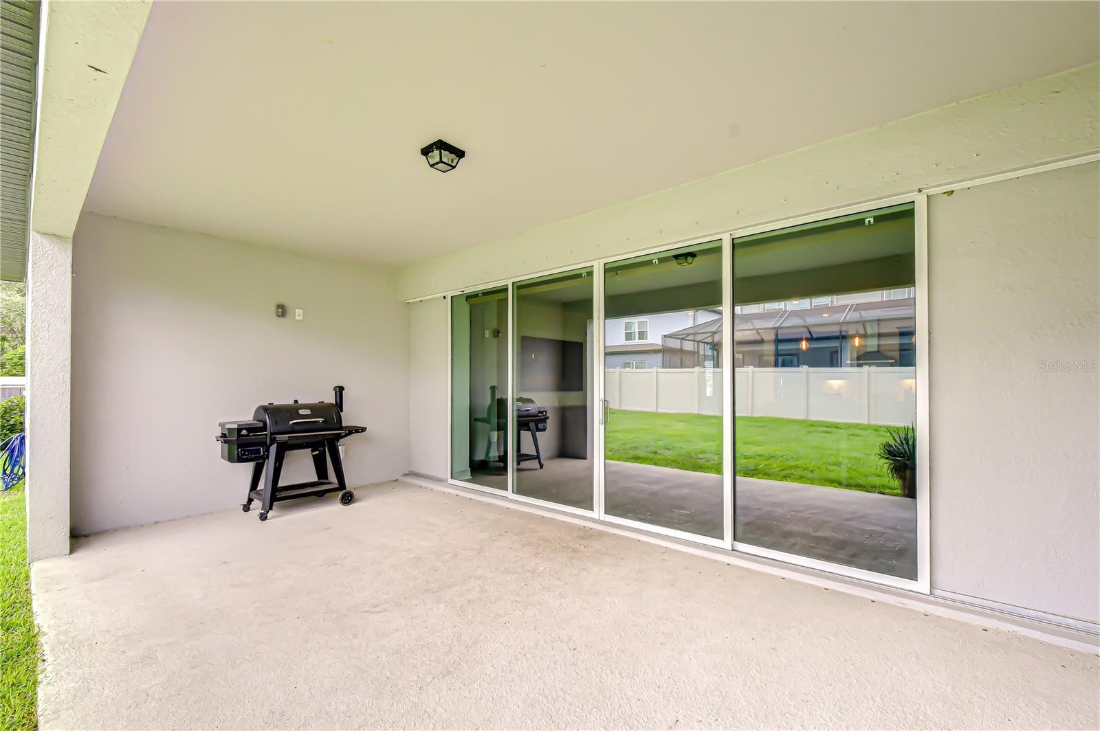 Covered outdoor living space overlooking the backyard.