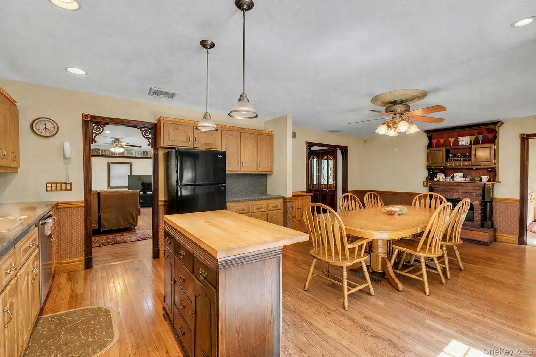 Kitchen featuring wood-finish flooring, recessed lighting, and a dark wood island with a butcher block countertop