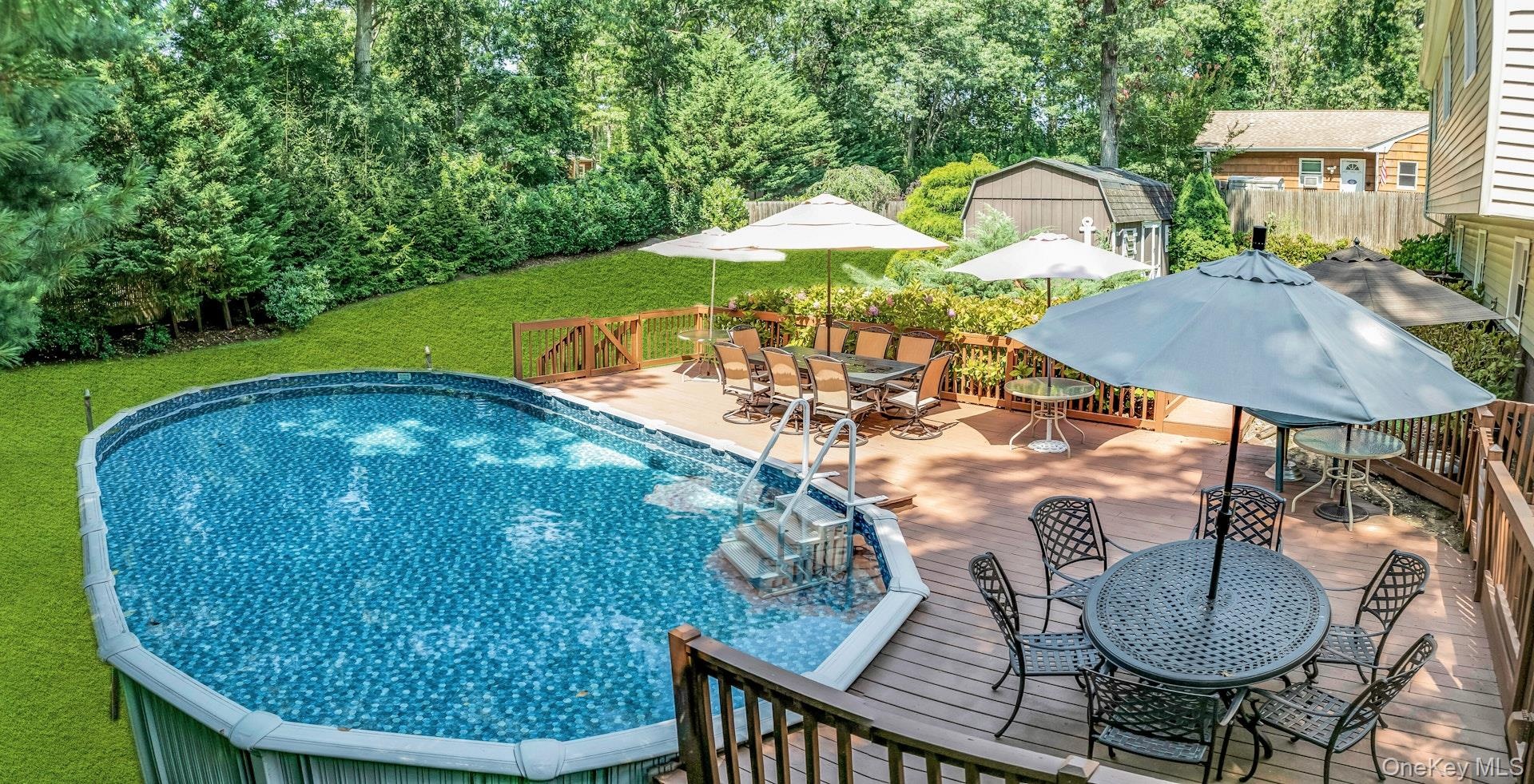 Expansive rear deck featuring a  pool with steps