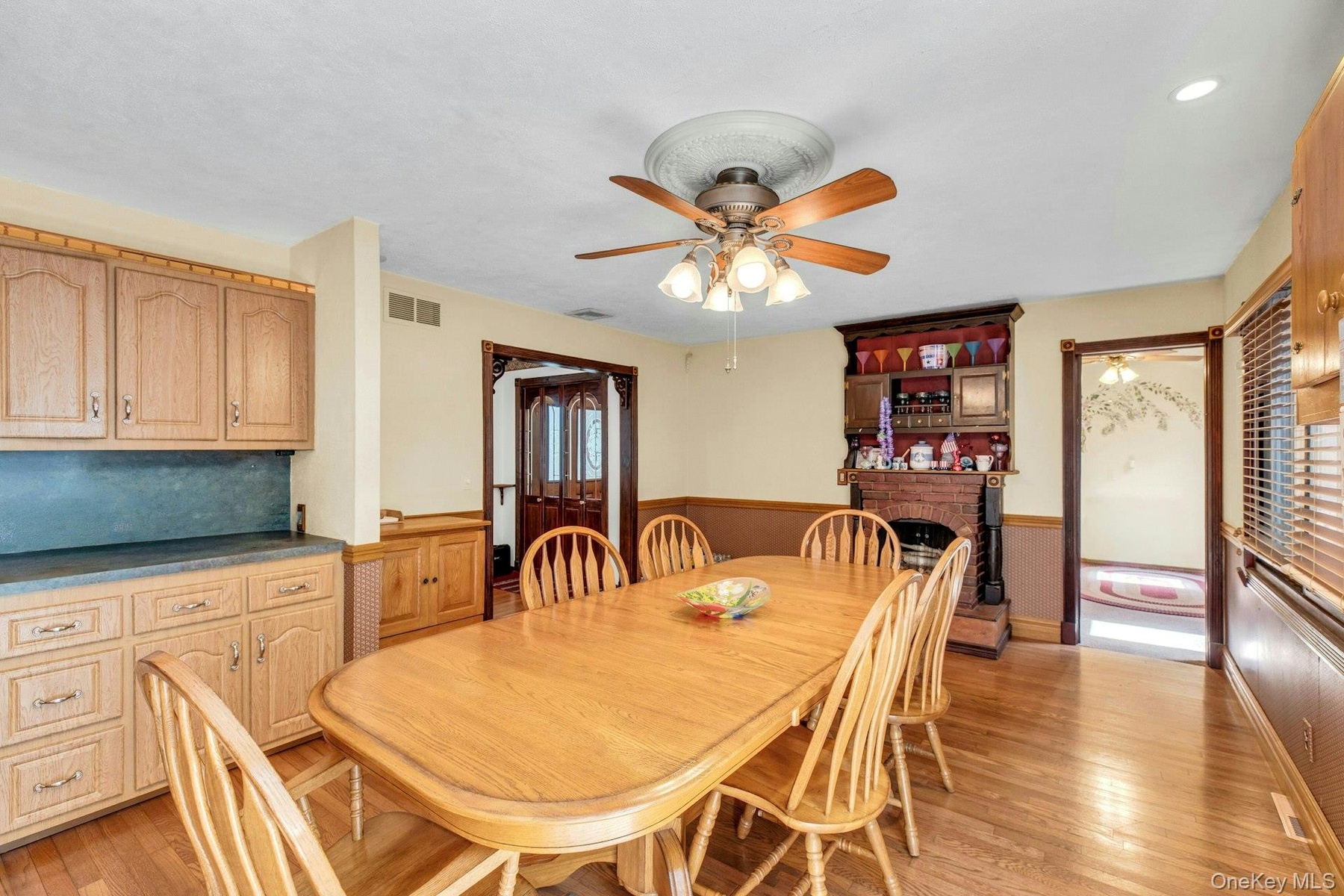 Dining area featuring wood-finish flooring and a ceiling fan with light fixture