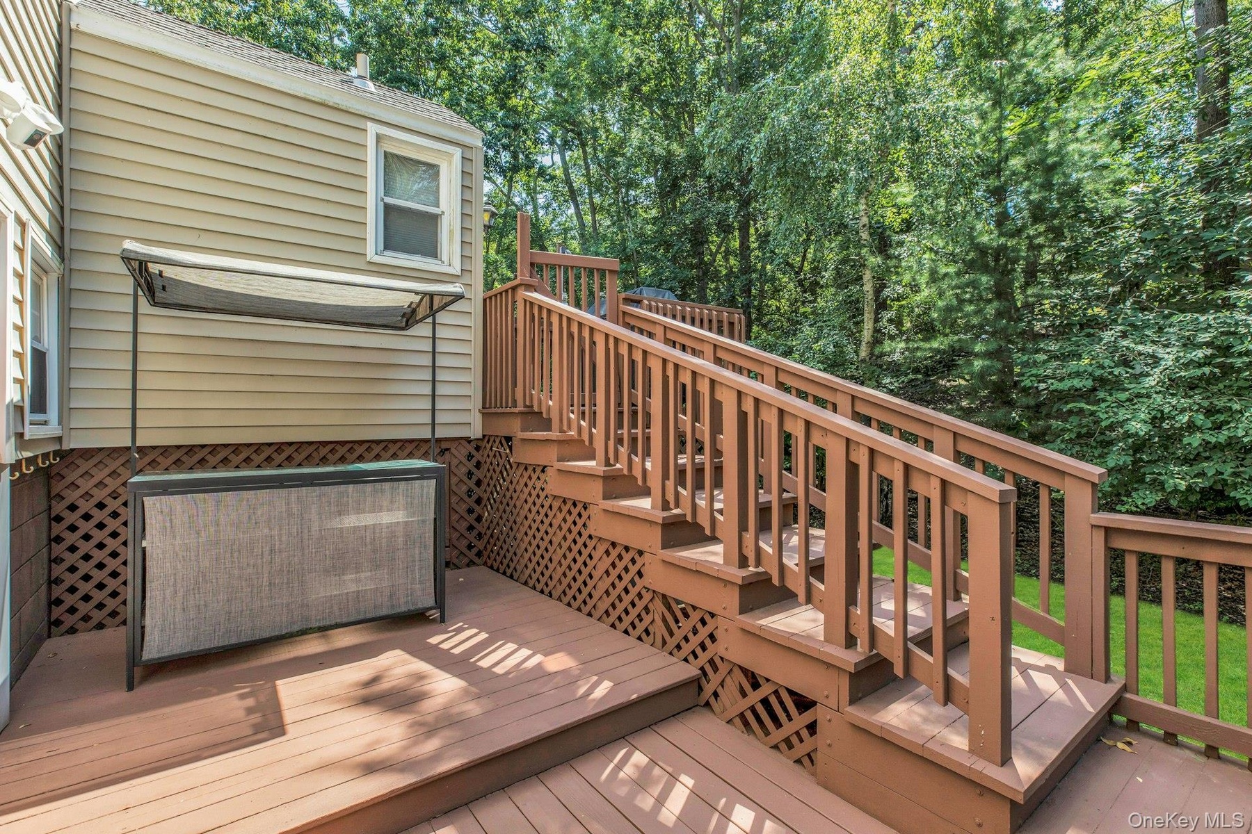 Multi-level wood deck featuring stained wood planking and railings