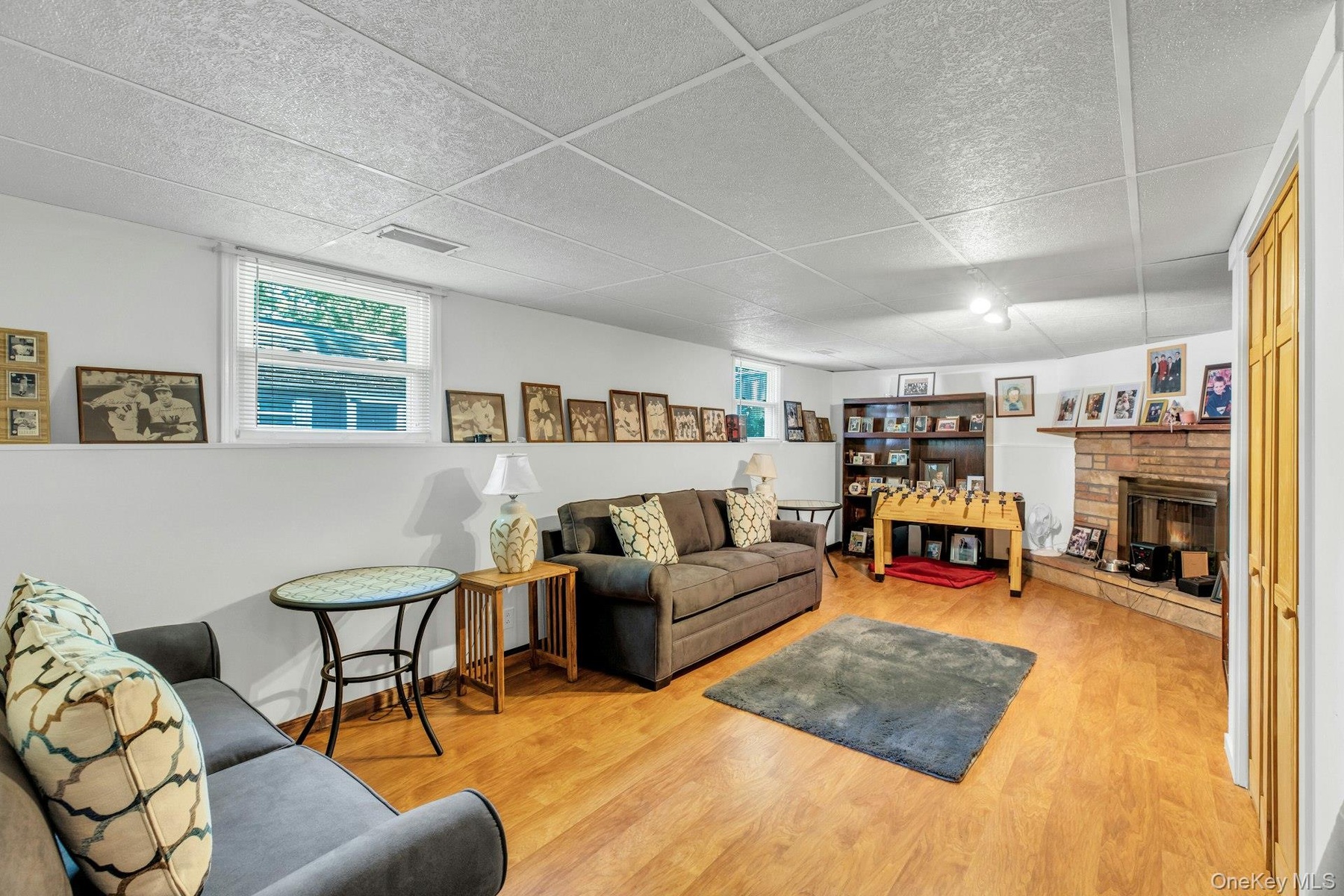 Finished Basement Family Room featuring warm wood-finish flooring, recessed ceiling lighting, and abundant wall space for display