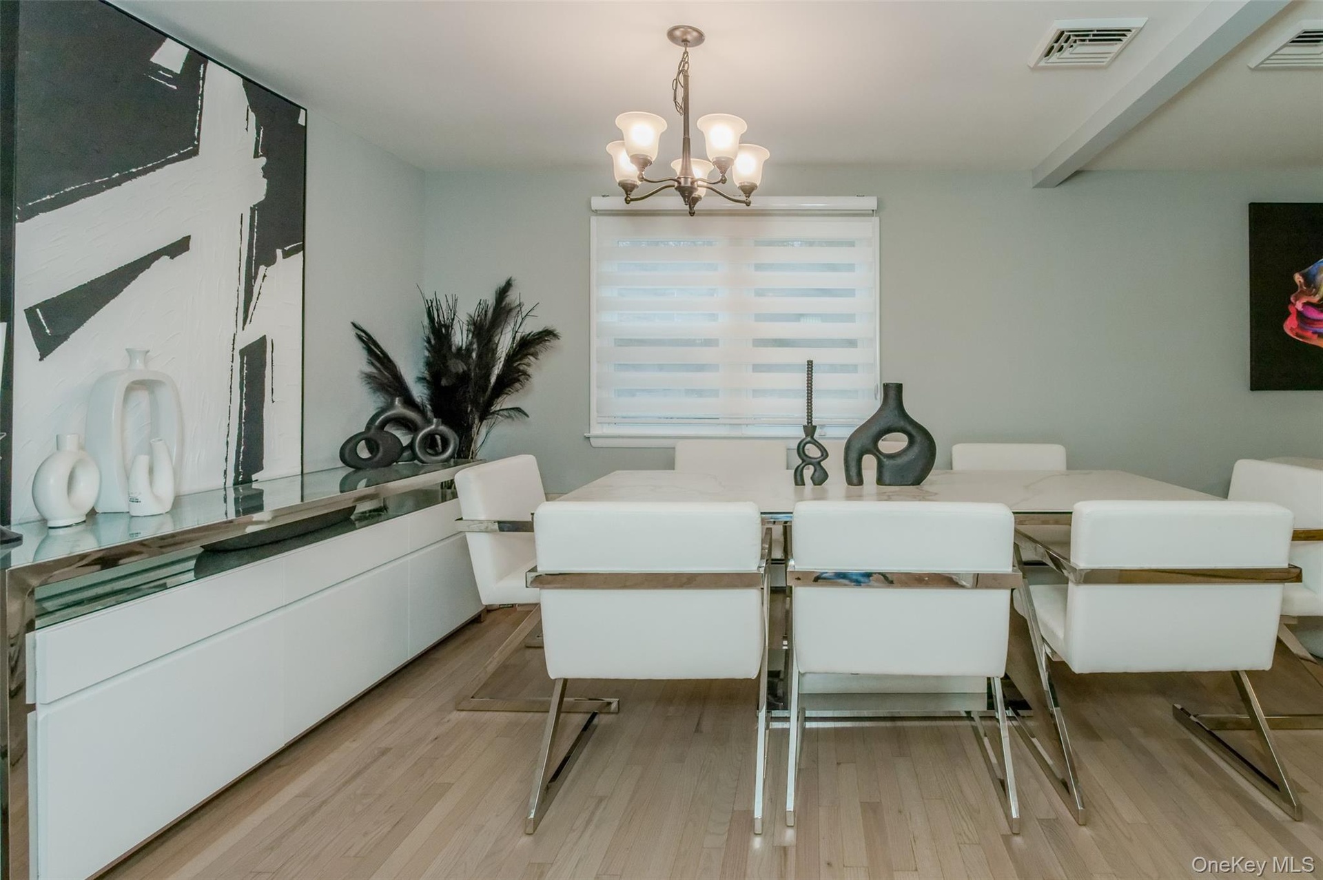 Dining room featuring a notable chandelier and light wood-type flooring