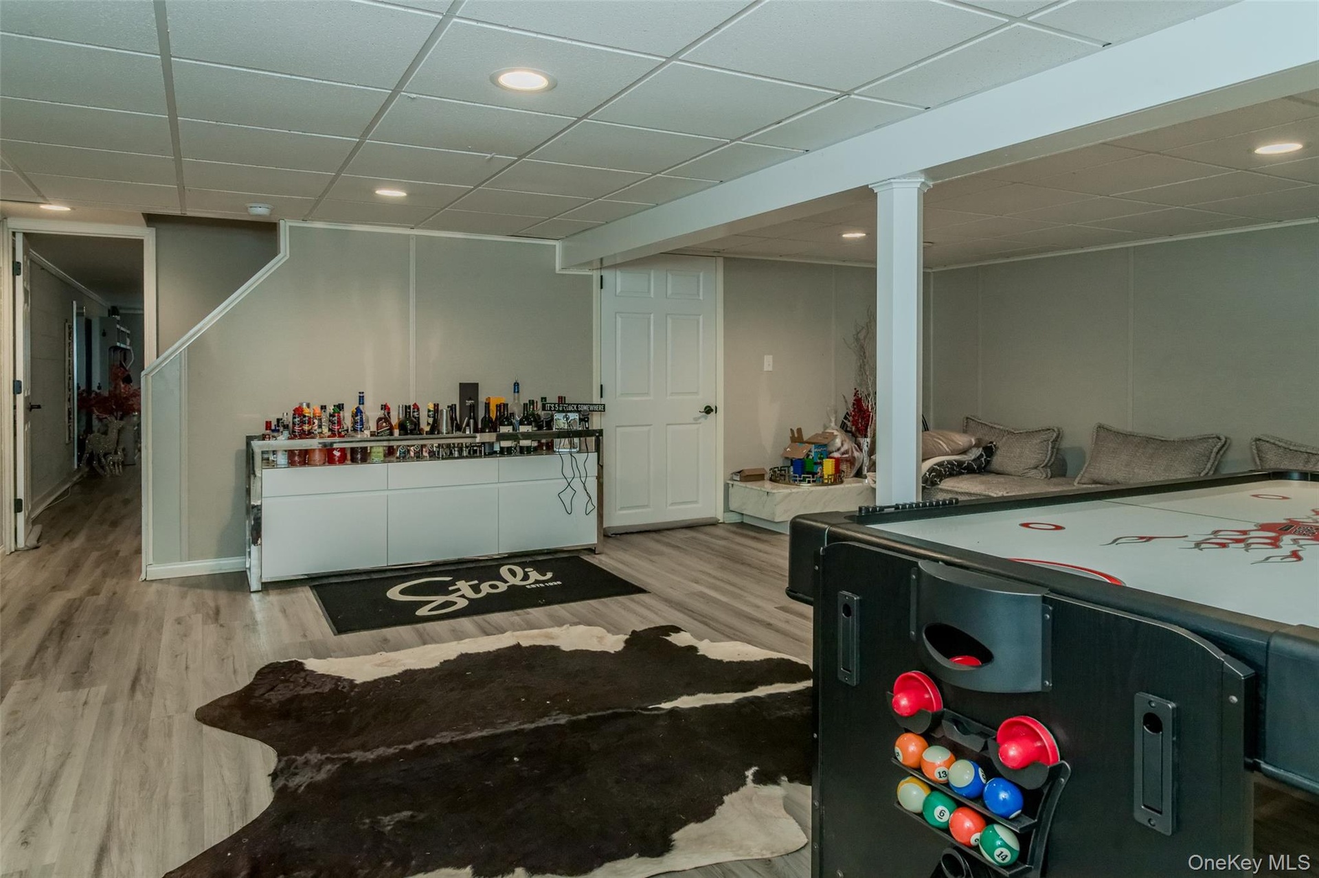 Rec room featuring a drop ceiling and light hardwood / wood-style floors