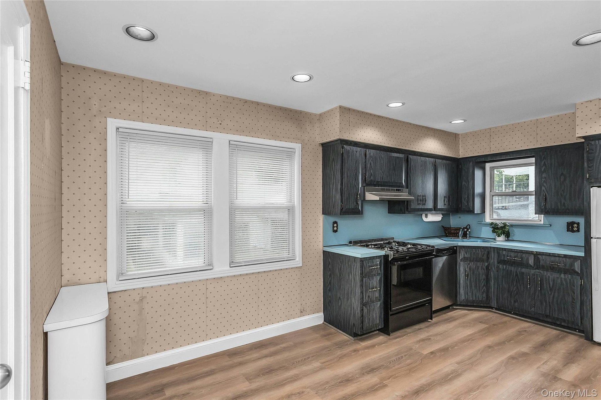 Kitchen featuring dark wood-finish cabinetry, and a full suite of appliances EIK