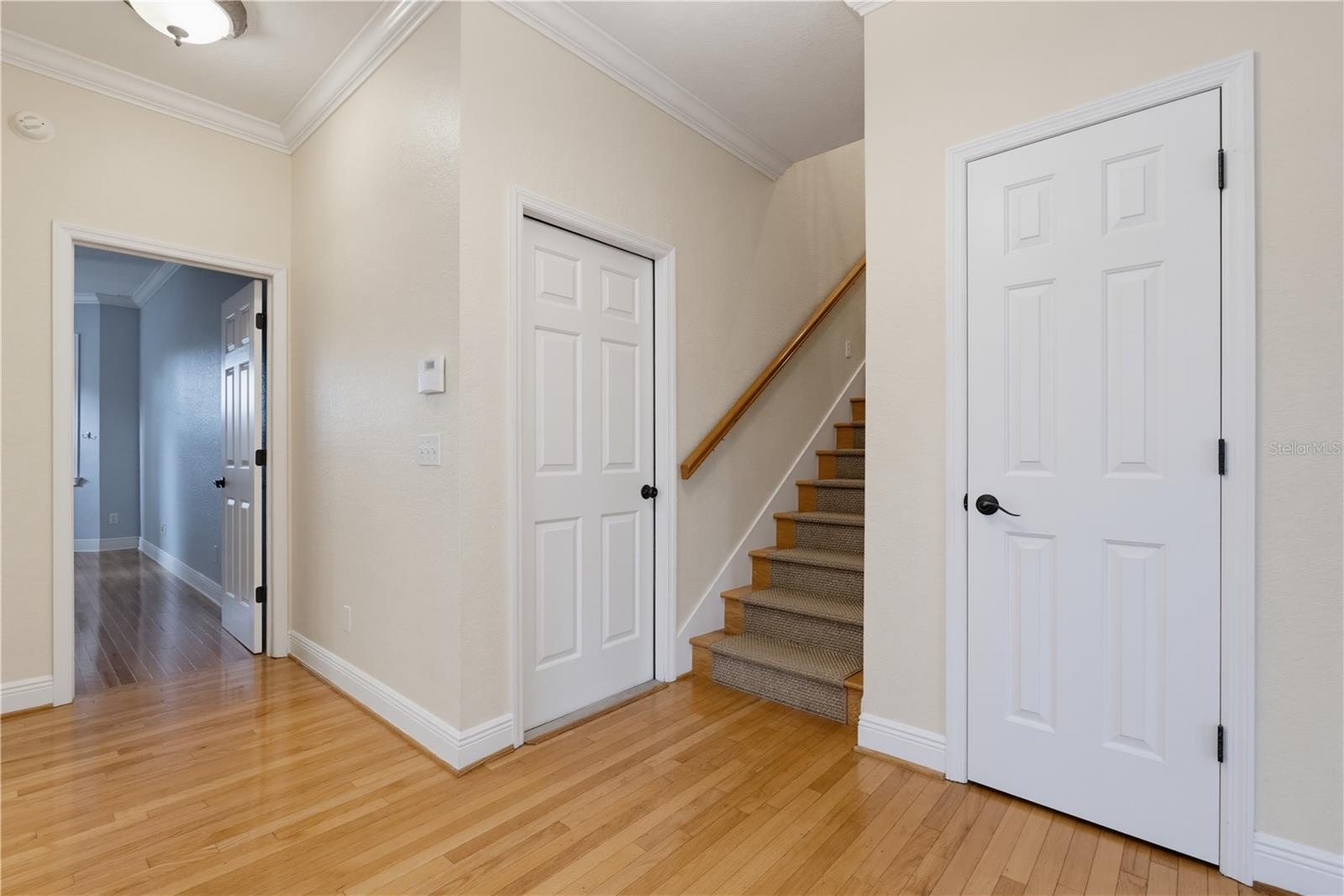 Looking towards Stairs, Garage Door and Coat Closet