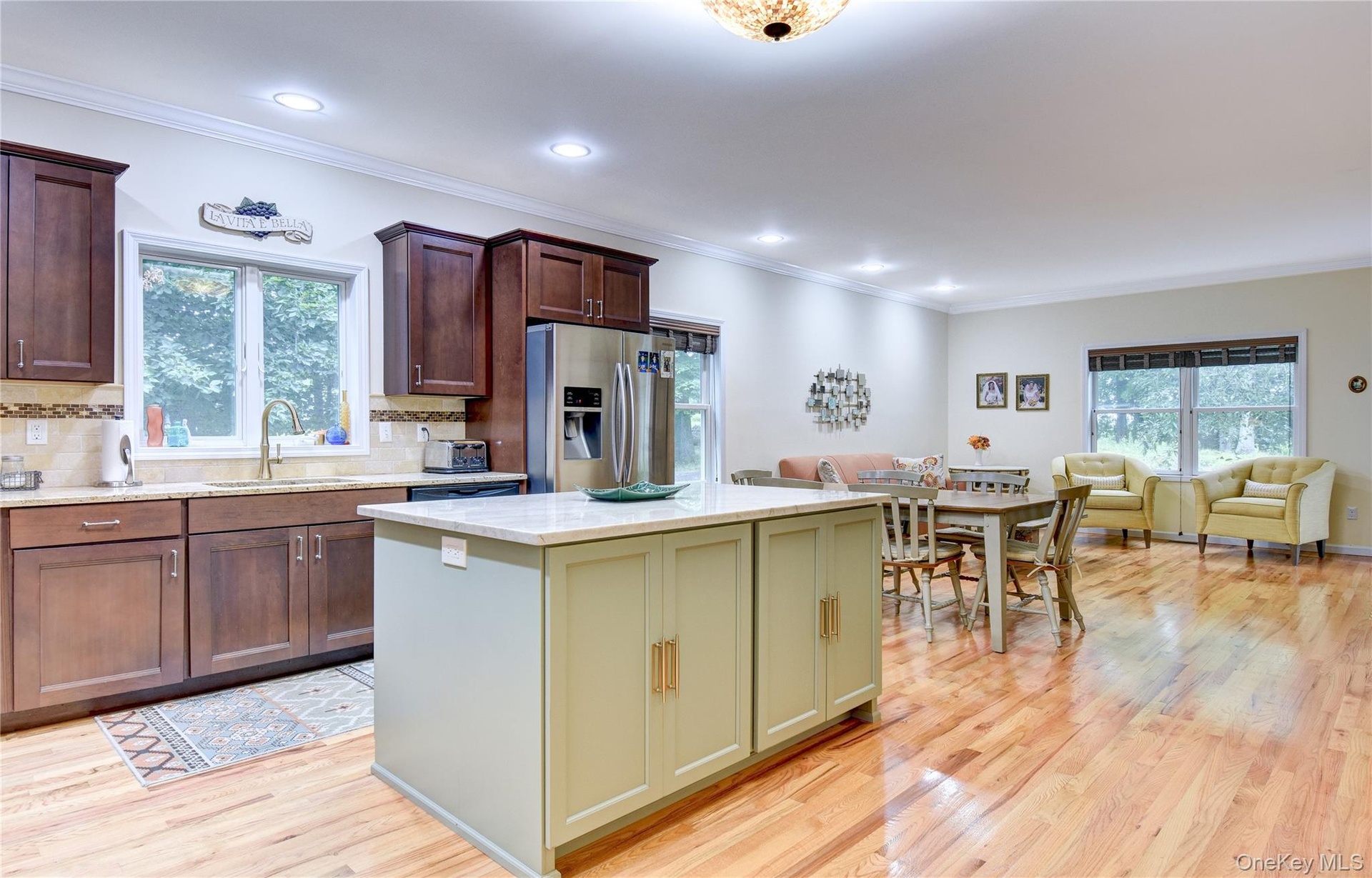 Legal accessory apartment: Open-concept living space featuring wood flooring, recessed lighting, and crown molding