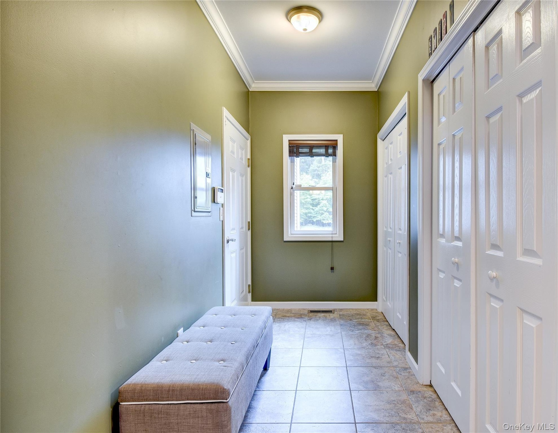 Hallway with entrance to garage and double pantries/closets