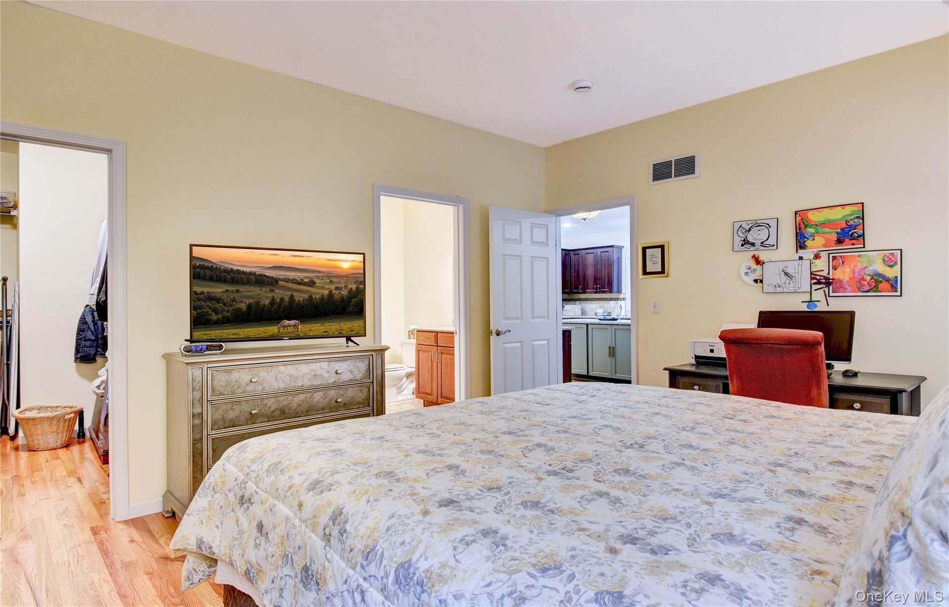 Legal accessory apartment: Bedroom featuring light yellow walls and wood flooring