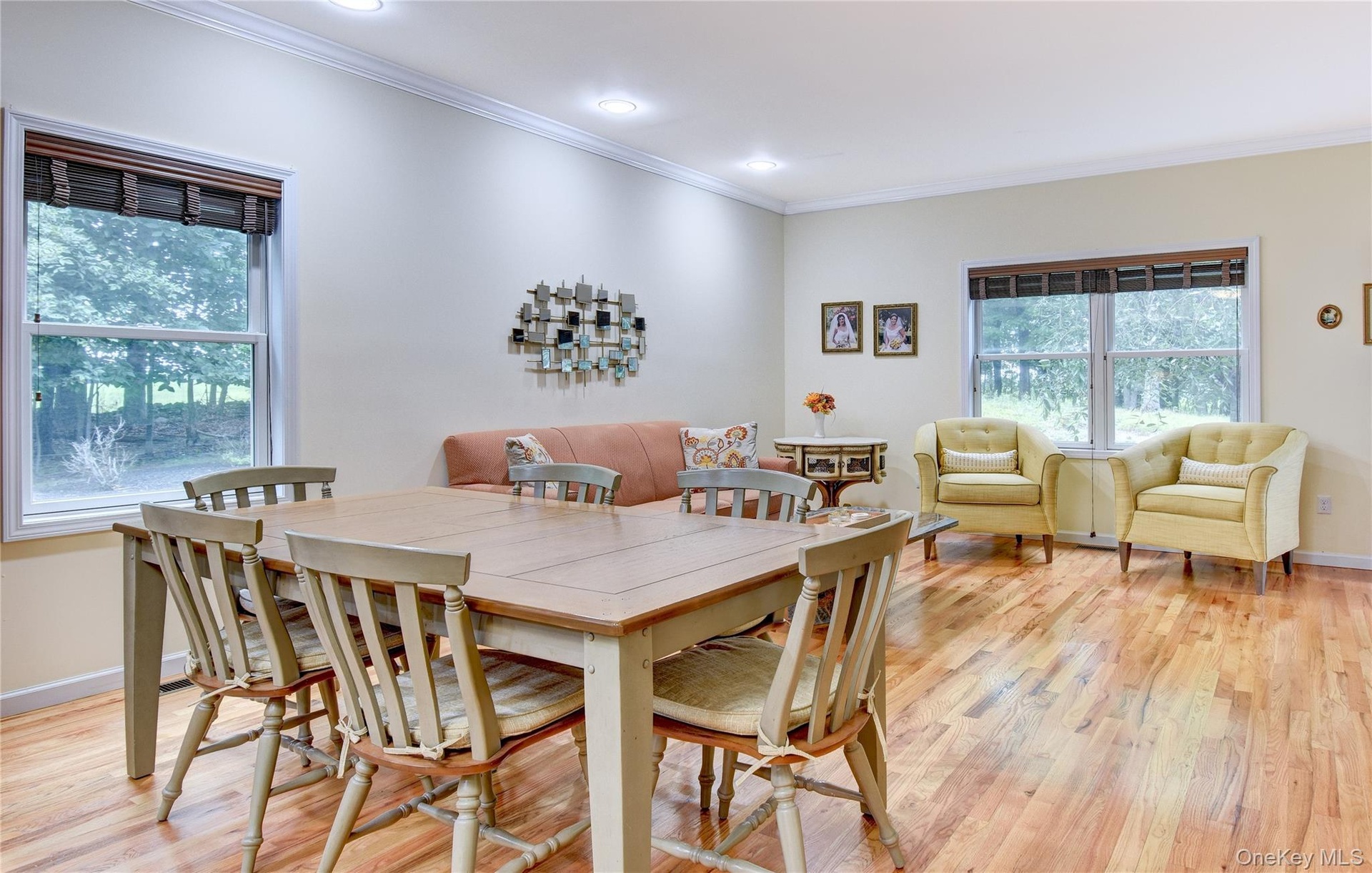 Legal accessory apartment: Open-concept living area featuring wood flooring, recessed lighting, and crown molding